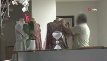 Eşinin mağazasına girip gelinliklerin üzerlerine kolonya döktü, tüpe çakmağı dayayınca tazyikli suyu yedi