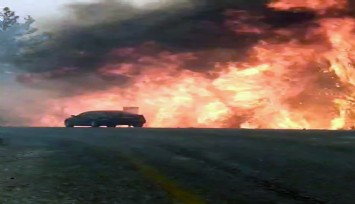 Orman yangınında araç alevlerin arasında kadı